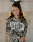 Rooted youth Christian hoodie front design — minimal kid-friendly ‘Rooted’ lettering inspired by Colossians 3:3.