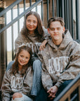 Unisex camo printRooted hoodie for youth and adults— midweight fleece inspired by faith and identity in Christ.